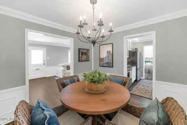 a view of a dining room with furniture wooden floor and chandelier