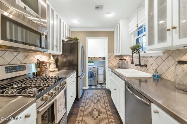 a kitchen with stainless steel appliances granite countertop a sink stove and refrigerator