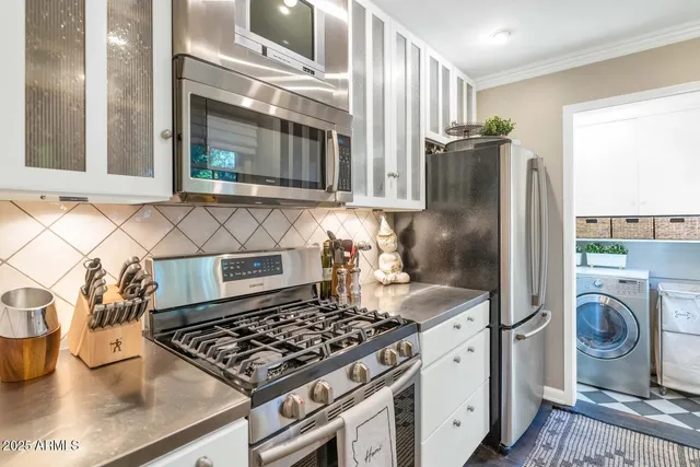 a kitchen with cabinets and a stove top oven