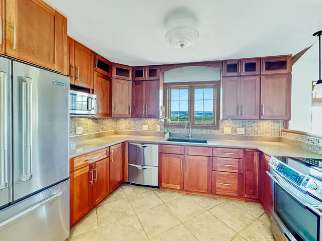 a view of kitchen and refrigerator