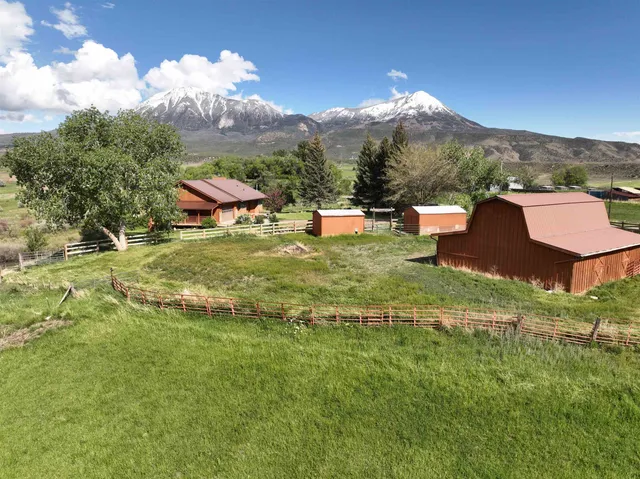 an aerial view of a house with big yard