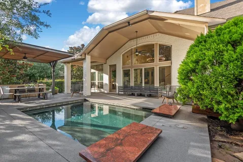 a view of a house with backyard and sitting area