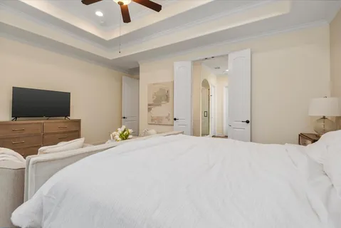 a bedroom with a bed and a flat screen tv