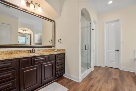 a bathroom with a tub sink and mirror