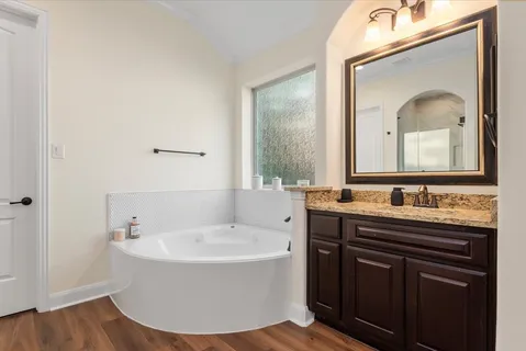 a spacious bathroom with a shower and a sink