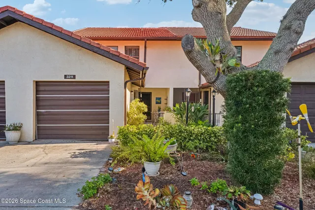 a house that has a plant in front of it