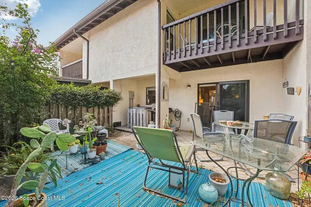 a view of a chairs and table in patio