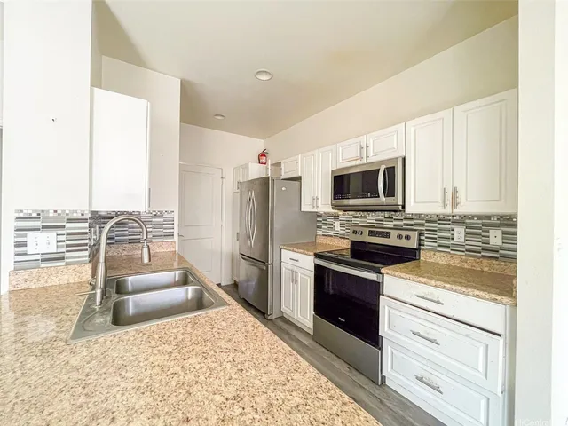 a kitchen with a refrigerator stove and oven
