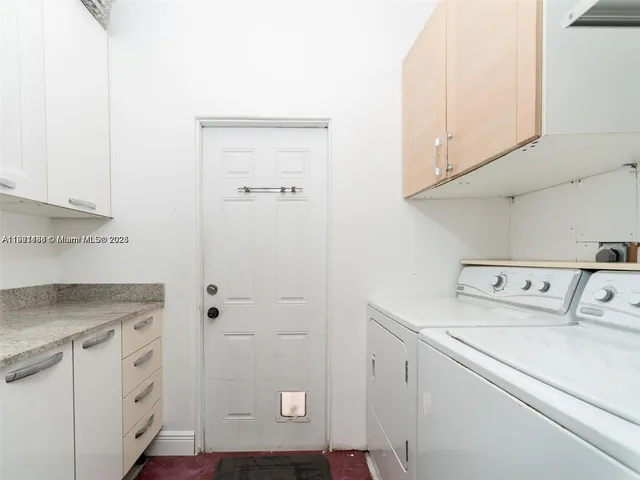 a view of storage and utility room with washer and dryer