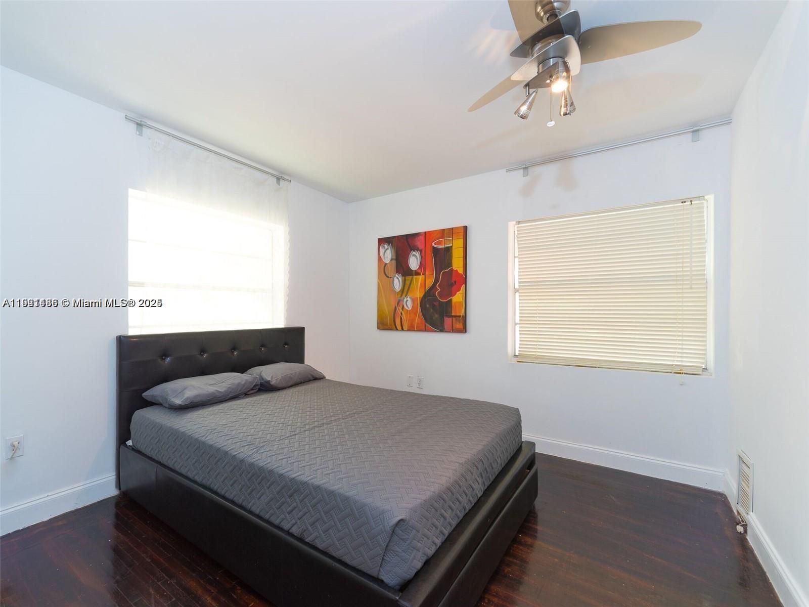 1509 Fletcher Street Hollywood, FL 33020 - Photo 7 of 16 a bedroom with a bed and wooden floor