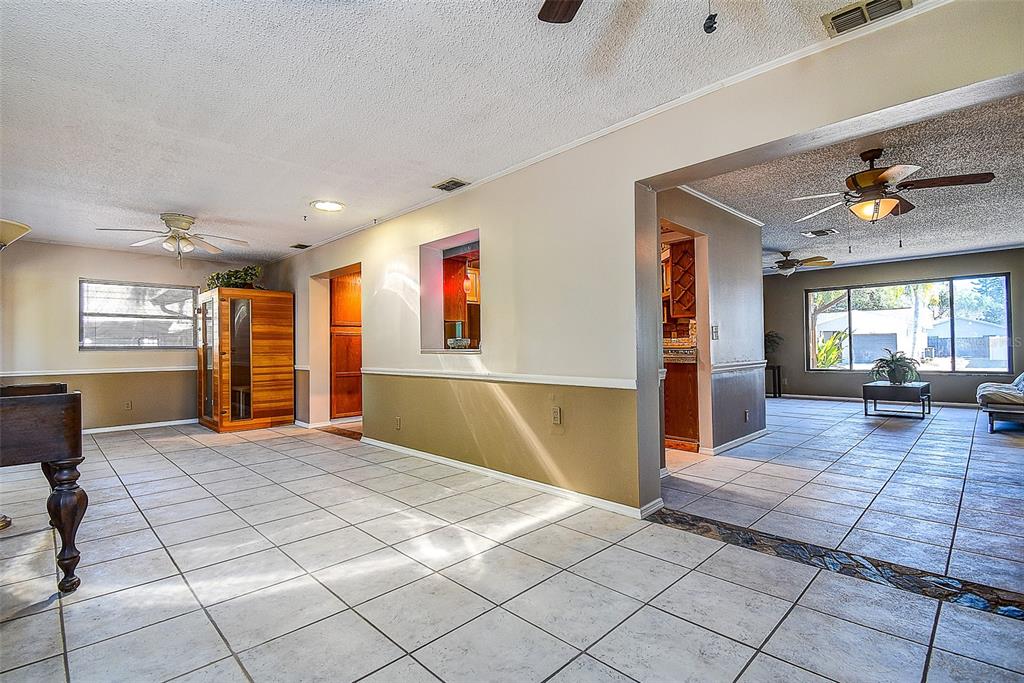 808 Helmsman Way Palm Harbor, FL 34685 - Photo 11 of 27 a living room with furniture and a window