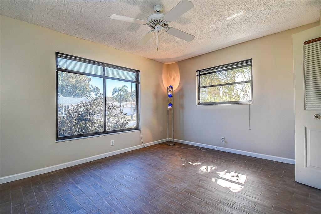 808 Helmsman Way Palm Harbor, FL 34685 - Photo 15 of 27 a view of an empty room with wooden floor and a window