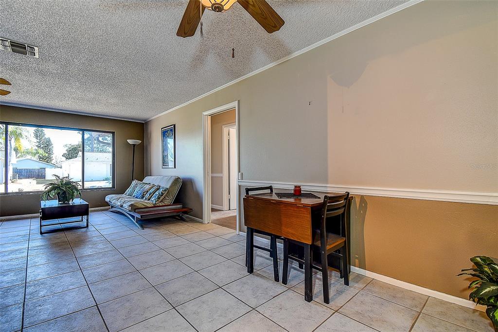 808 Helmsman Way Palm Harbor, FL 34685 - Photo 7 of 27 a living room with furniture and a window