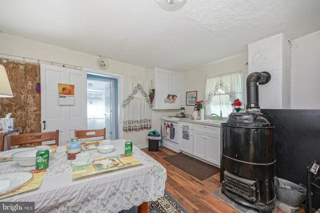 a kitchen with stainless steel appliances granite countertop a stove and white cabinets
