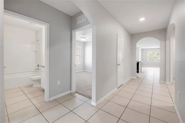 a kitchen with granite countertop a refrigerator and a stove top oven