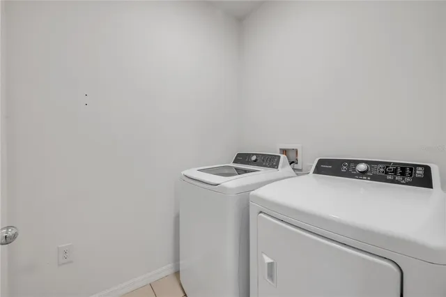 a kitchen with a granite countertop sink and natural light