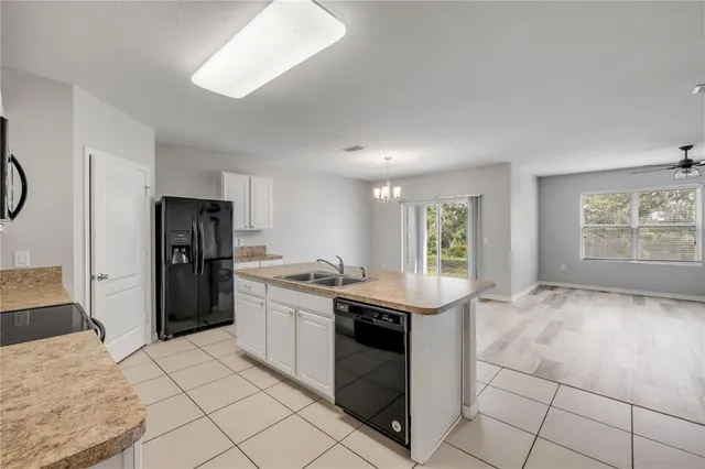 a view of a dining room with furniture wooden floor and chandelier