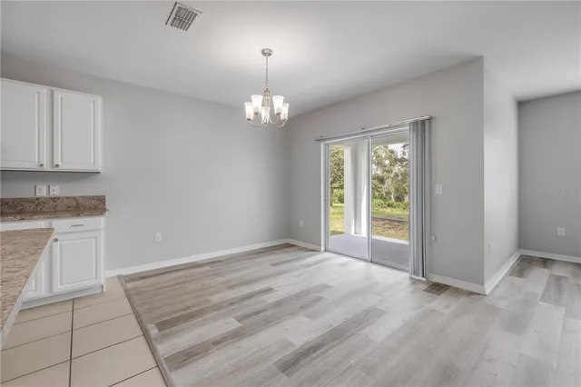 a spacious bathroom with a granite countertop sink a mirror and a shower