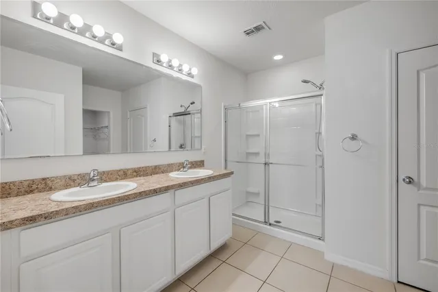 a aerial view of a house with a yard and large trees