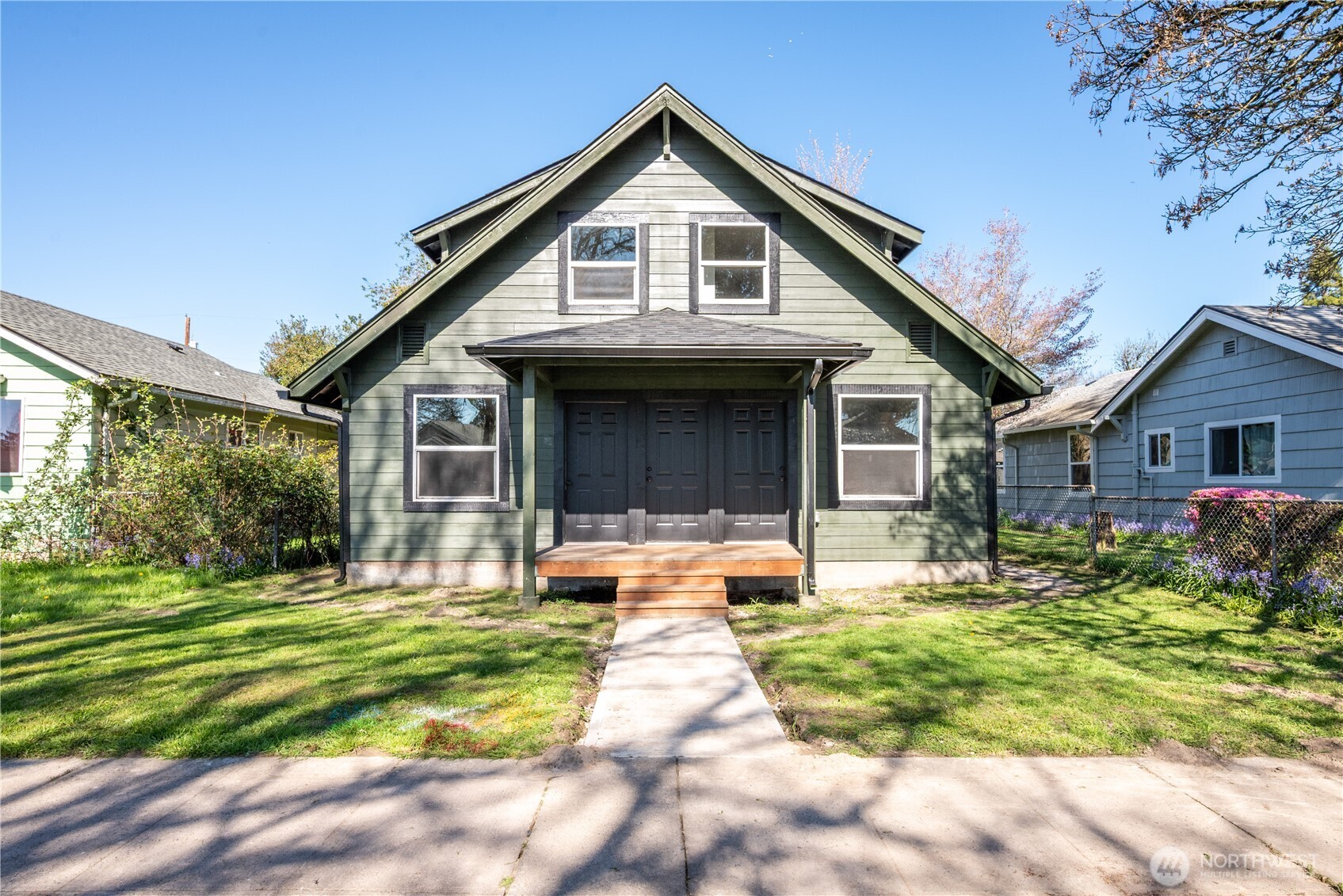 a front view of house with yard and green space