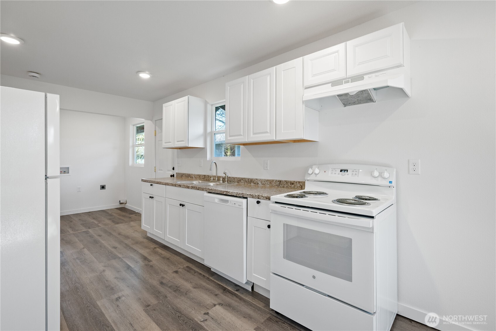 285 20th Avenue Longview, WA 98632 - Photo 16 of 37 a kitchen with cabinets appliances and wooden floor