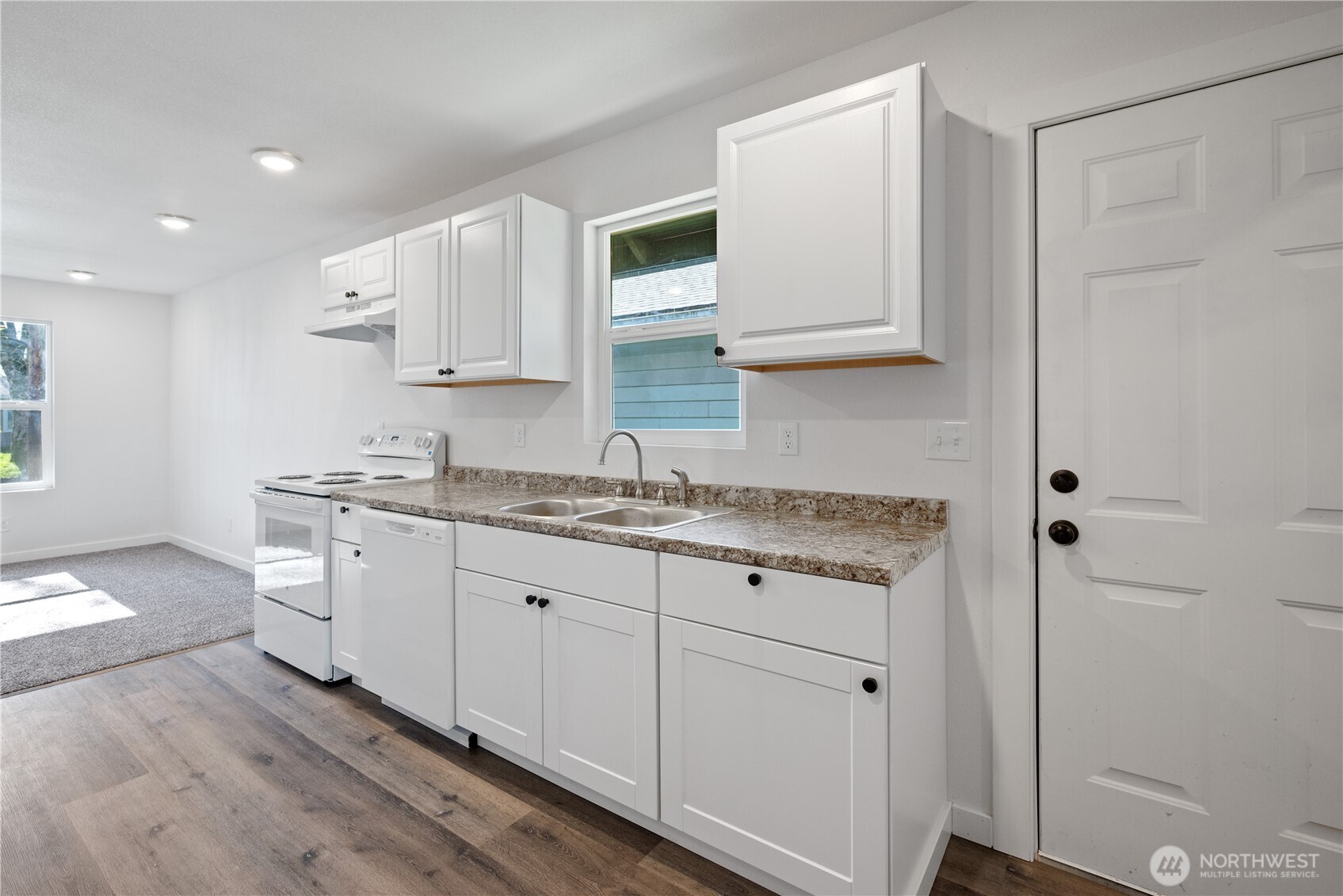 285 20th Avenue Longview, WA 98632 - Photo 25 of 37 a kitchen with granite countertop white cabinets and white appliances