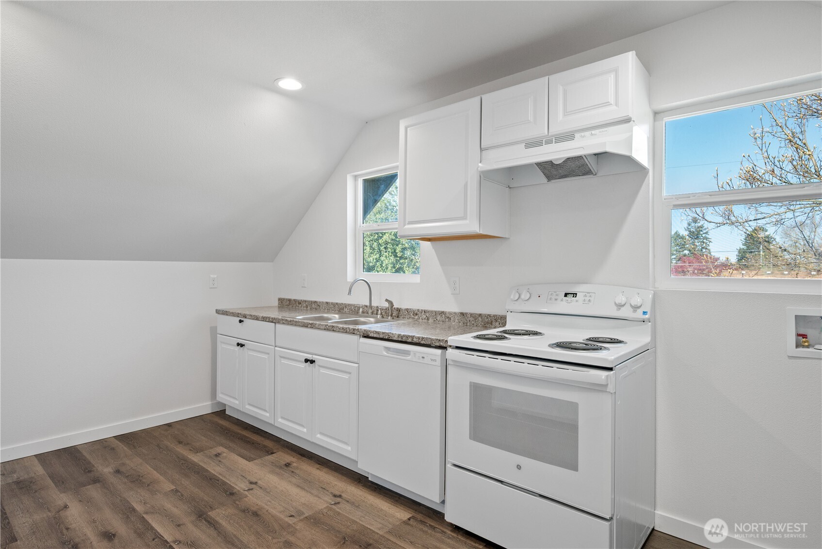 285 20th Avenue Longview, WA 98632 - Photo 5 of 37 a kitchen with granite countertop white cabinets and white appliances