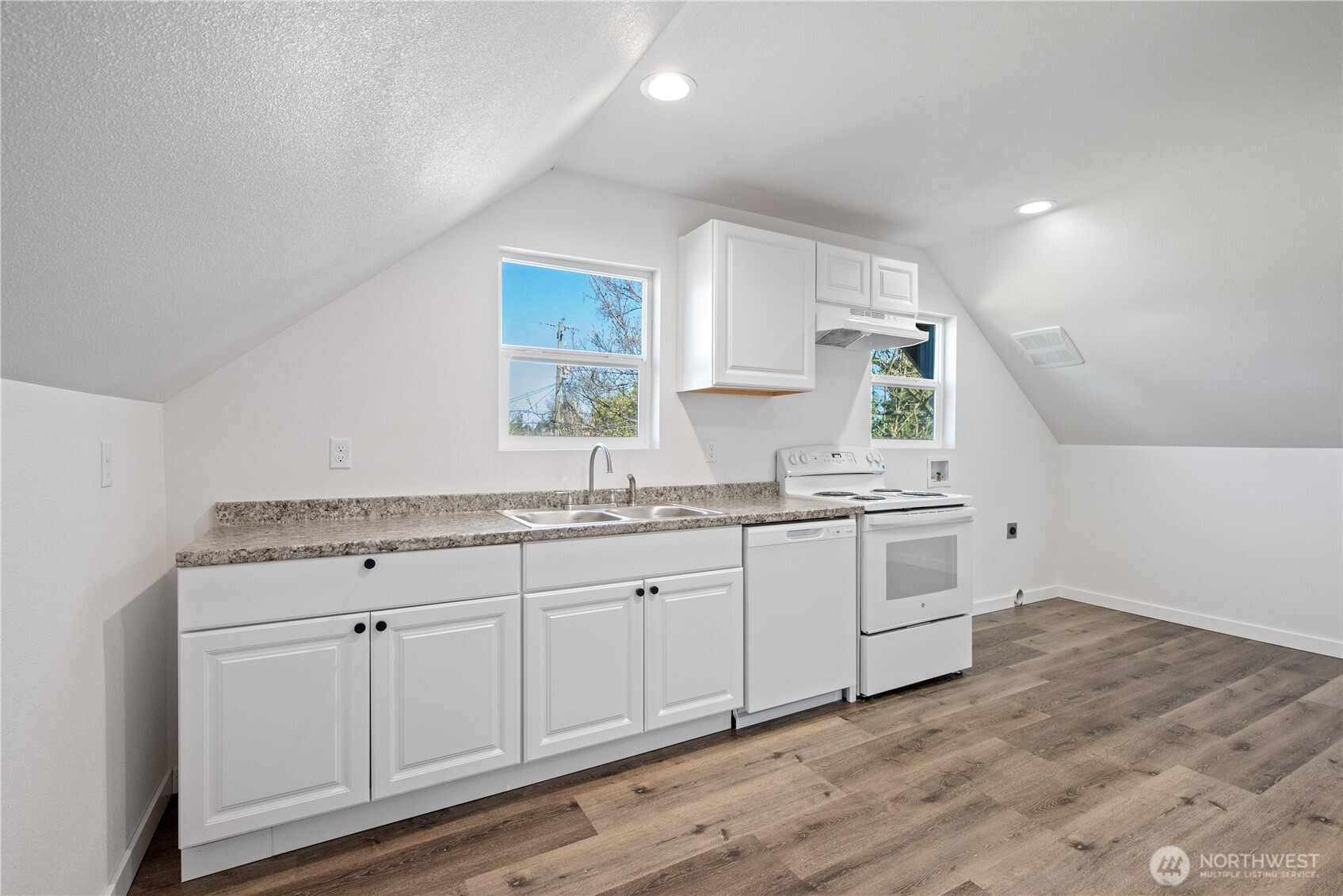 285 20th Avenue Longview, WA 98632 - Photo 7 of 37 a kitchen with granite countertop white cabinets and white appliances
