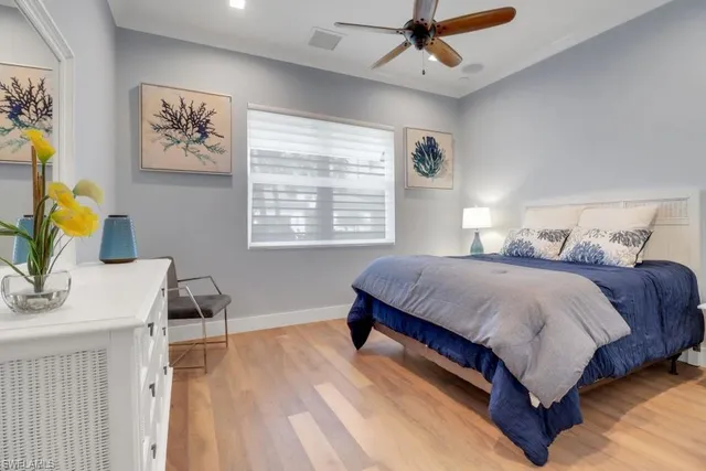 a bedroom with a bed and a painting on the wall