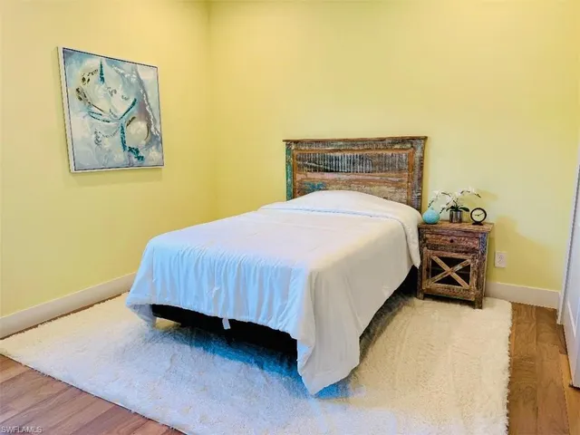 a view of a livingroom with wooden floor and a window