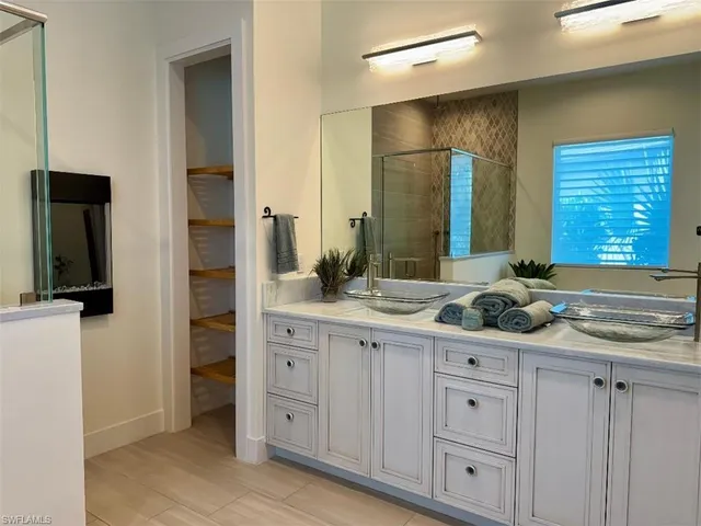 a bathroom with a sink a toilet a shower and a mirror