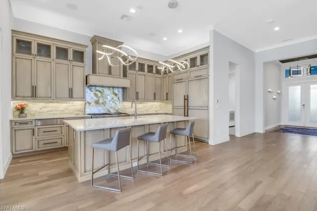 a kitchen with stainless steel appliances granite countertop a stove and a sink
