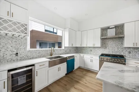 a kitchen with a sink stove and cabinets