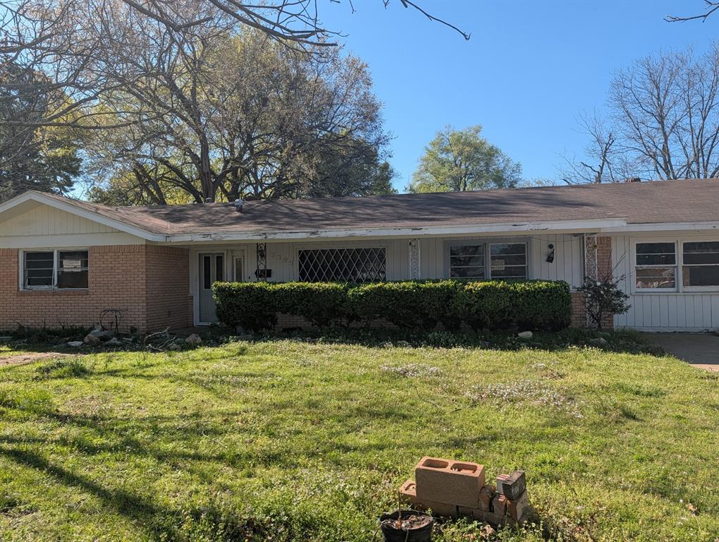 3395 Bonham Street Paris, TX 75460 - Photo 1 of 5 a backyard of a house with potted plants and large tree