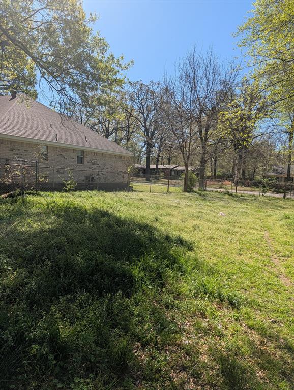 3395 Bonham Street Paris, TX 75460 - Photo 3 of 5 a view of a yard with an trees