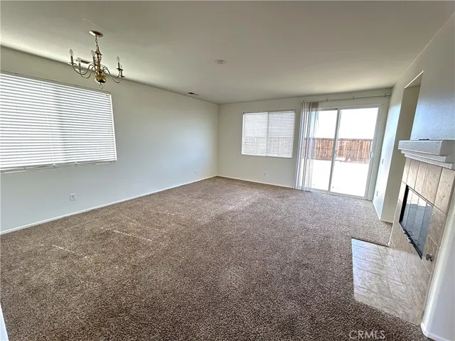 a view of an empty room with glass door