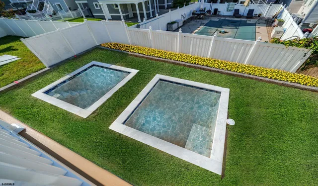 a view of a house with a big yard and large trees