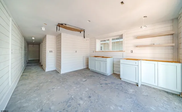 wooden floor and white cabinets in a room
