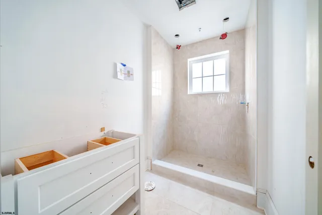 a bathroom with a bathtub and shower