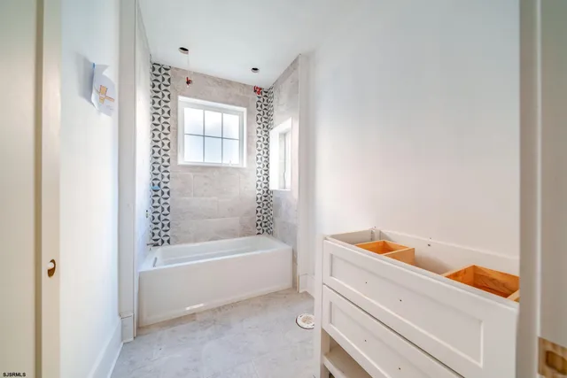 a bathroom with a bathtub and a shower