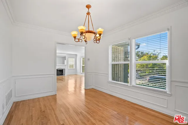 a view of a room with wooden floor and windows