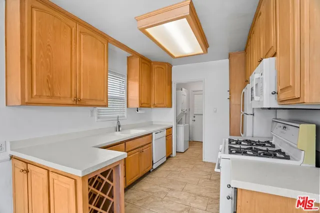 a kitchen with stainless steel appliances granite countertop a sink a stove and a refrigerator