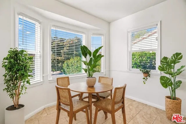 a dining room with furniture window and wooden floor
