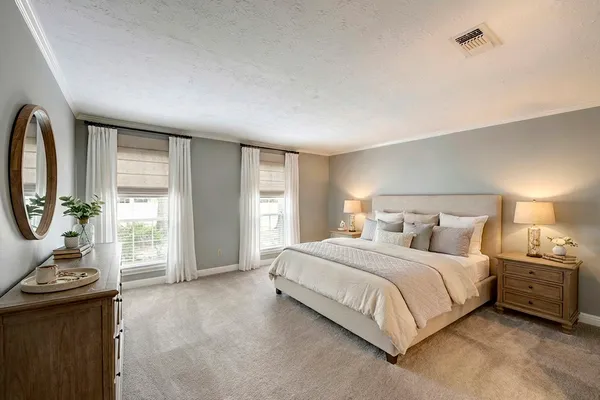 a bedroom with a bed and a dresser with mirror