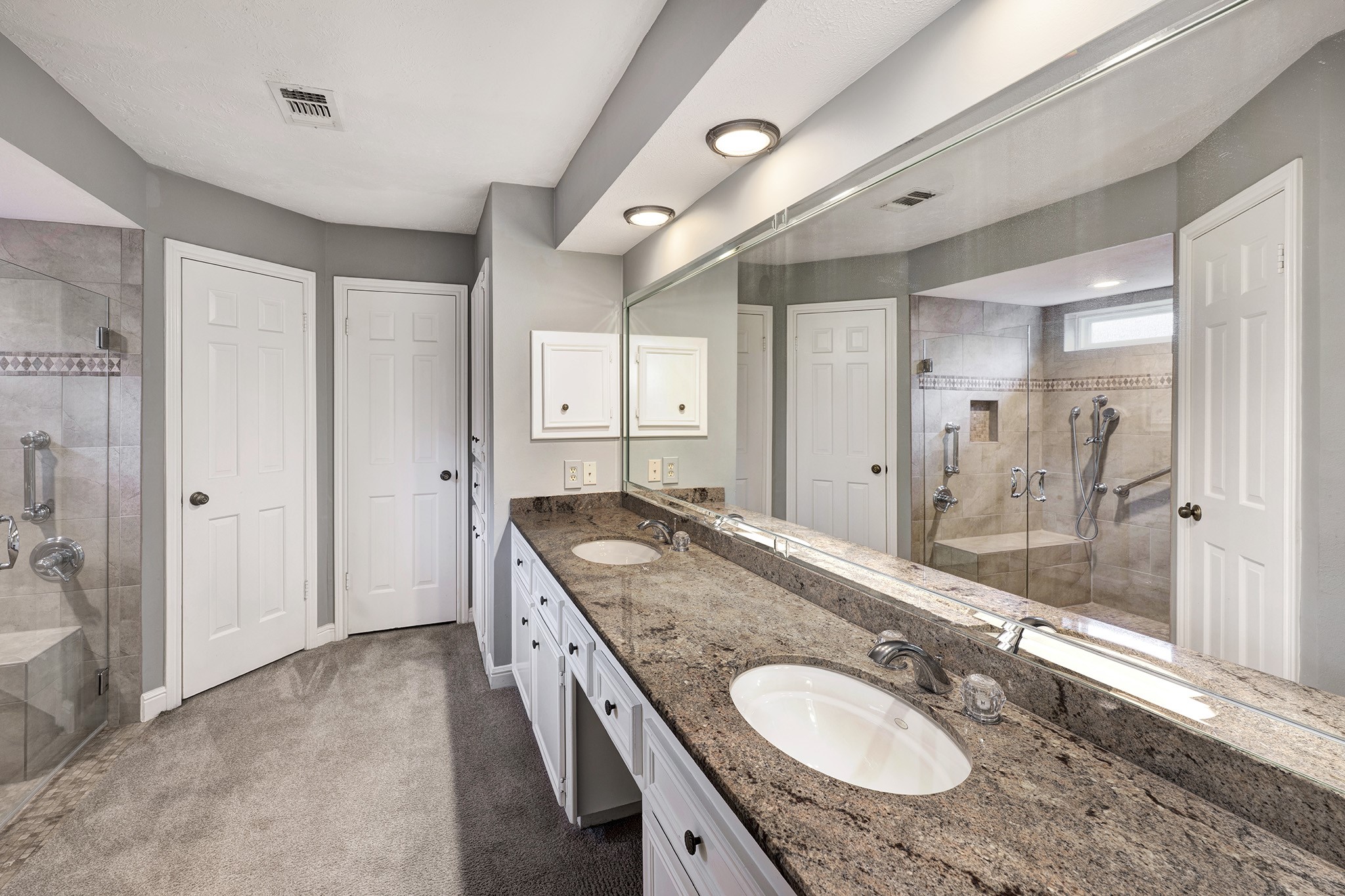 6623 Ampton Drive Spring, TX 77379 - Photo 14 of 26 a bathroom with a granite countertop double vanity sink and a mirror