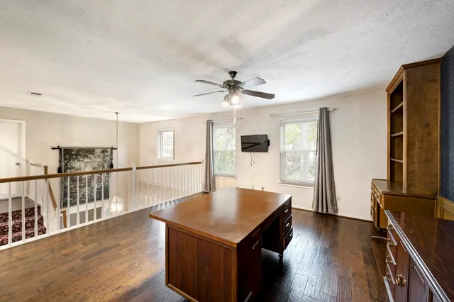 a kitchen with stainless steel appliances a kitchen island hardwood floor sink stove and a refrigerator