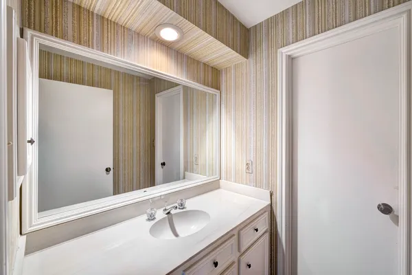 a bathroom with a sink and a mirror
