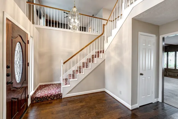 a view of entryway and hall with wooden floor