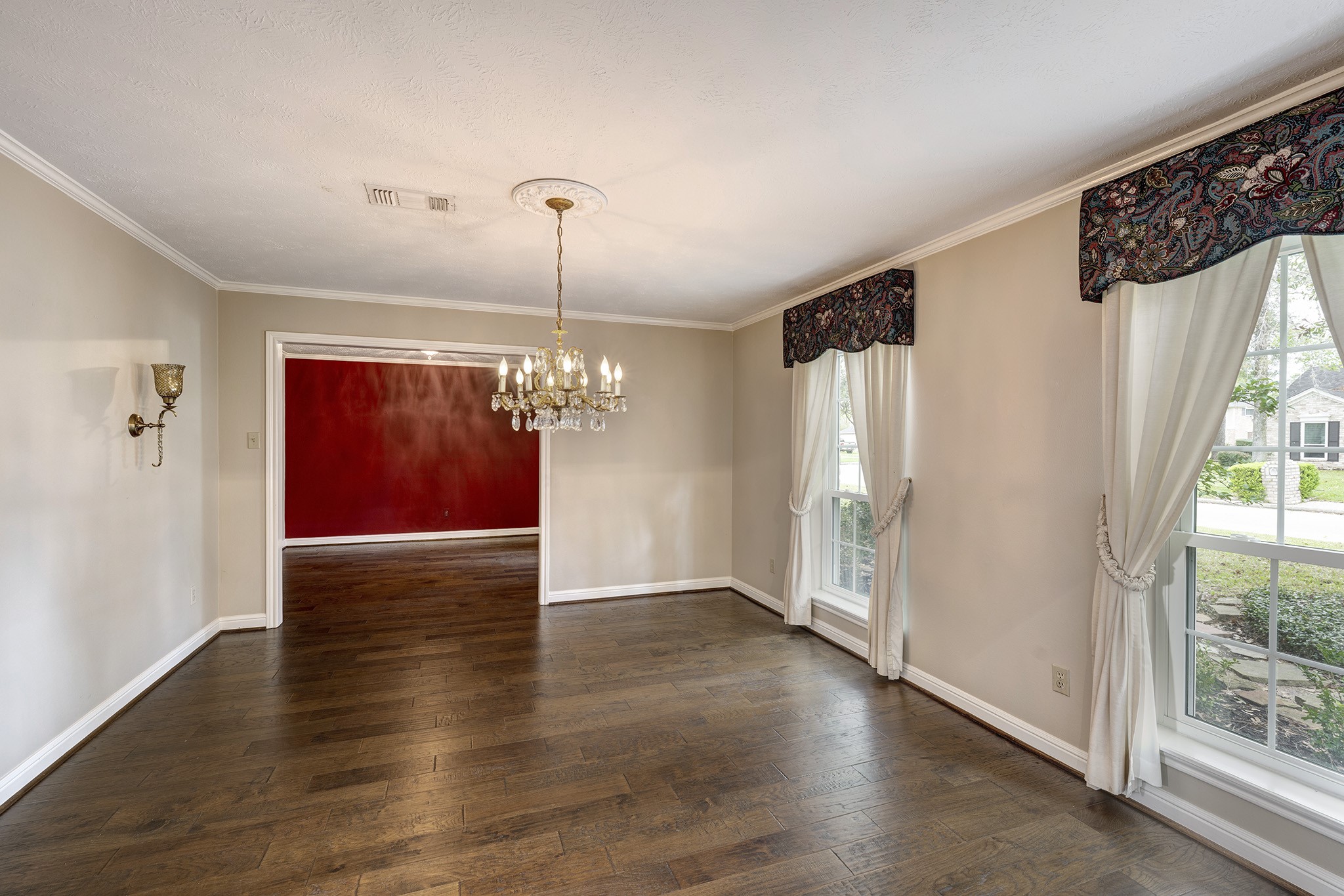 6623 Ampton Drive Spring, TX 77379 - Photo 5 of 26 a view of a livingroom with wooden floor staircase and kitchen view