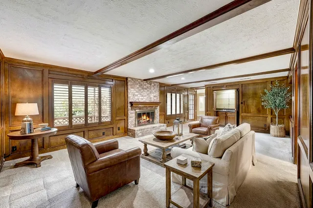 a living room with furniture and large windows